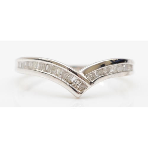 544 - A 9ct white gold brilliant and baguette cut diamond ring, O, 1.9gm.