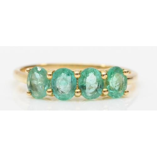 545 - A 9ct gold four stone emerald dress ring, O, 1.8gm.