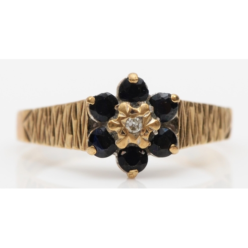 554 - A 9ct gold sapphire and diamond floral dress ring, M, 1.9gm.