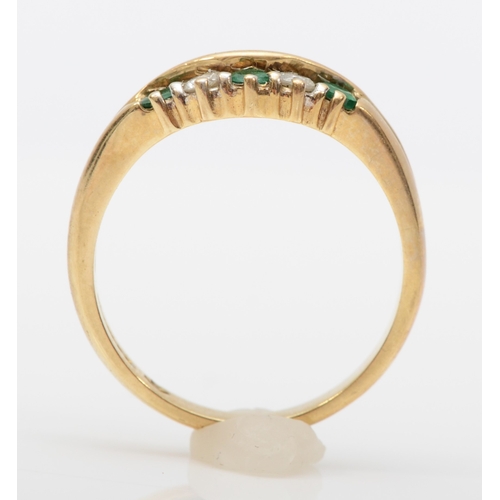 557 - A 9ct gold emerald and brilliant cut diamond dress ring, O, 3gm.