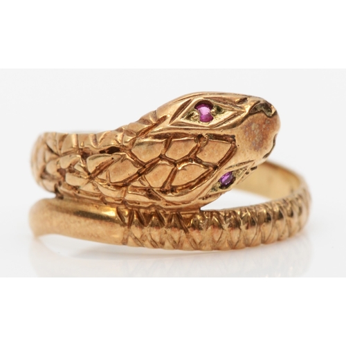 563 - A 9ct gold snake ring, set with ruby eyes, London 1983, P, 2.7gm.