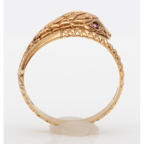 563 - A 9ct gold snake ring, set with ruby eyes, London 1983, P, 2.7gm.