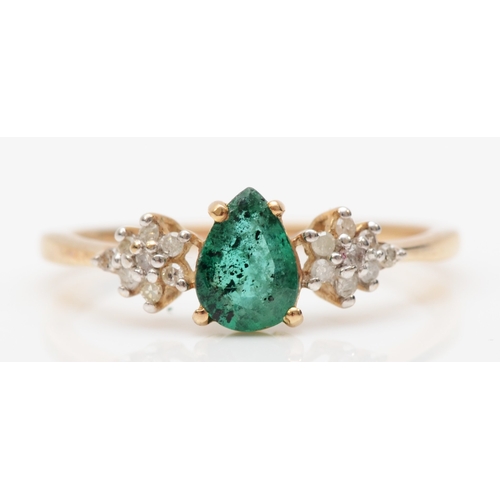 564 - A 9ct gold pear cut emerald and brilliant cut diamond dress ring, O, 1.5gm.