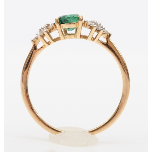 564 - A 9ct gold pear cut emerald and brilliant cut diamond dress ring, O, 1.5gm.