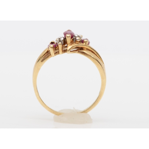 565 - A 10k gold ruby and diamond dress ring, K, 1.8gm.