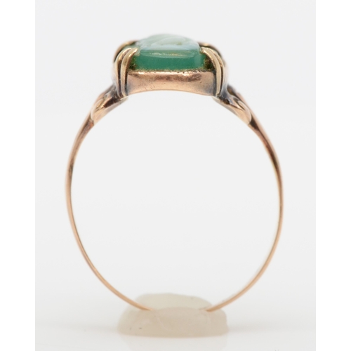 573 - A 9ct gold green glass cameo ring, decorated with a maiden in a flowing gown, M, 2gm.