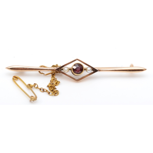 589 - An Edwardian 15ct rose gold garnet and seed pearl bar brooch, safety chain and original box, 55mm, 2... 