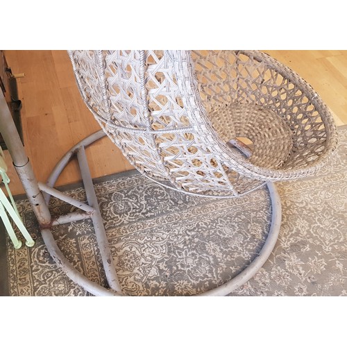 39 - A large garden hanging swing chair, all weather faux wicker, raised on a tubular steel stand.