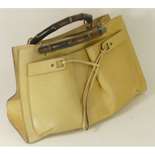 305 - Gucci, pale yellow, hide leather, tote handbag with bamboo handles. Stamped Gucci on the outside and... 