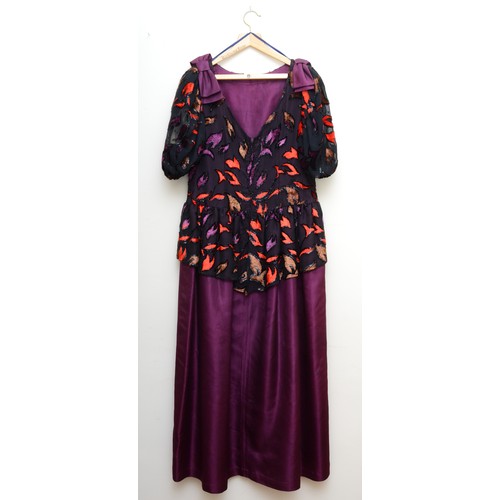 301 - A ladies ball gown with a full purple floor length skirt with a puff sleeved top in an abstract patt... 