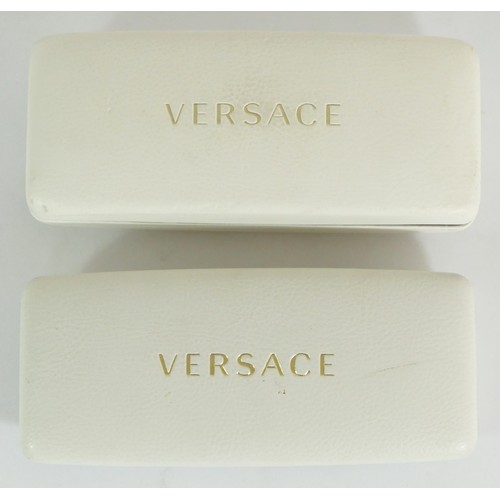 308 - A pair of ladies Versace sunglasses, together with a pair of Versace prescription glasses, cased. (2... 