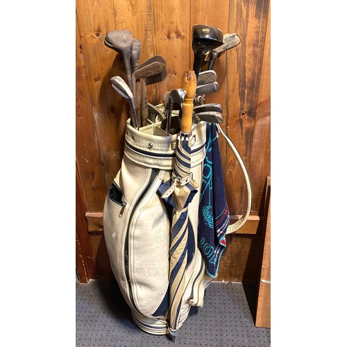 89 - A selection of vintage and modern golf clubs with golf bag.