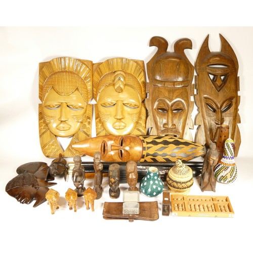 125 - A box of 20th century carved wooden African wall masks, together with other ethnic and tribal items.