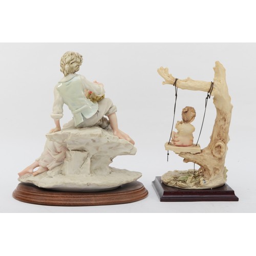 163 - Two 20th century painted resin Capodimonte figures, each raised on a wooden plinth, male and female ... 