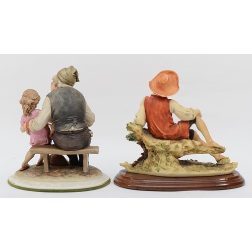 165 - Two 20th century Capodimonte painted porcelain figures, man and girl reading wit dog and their feet,... 