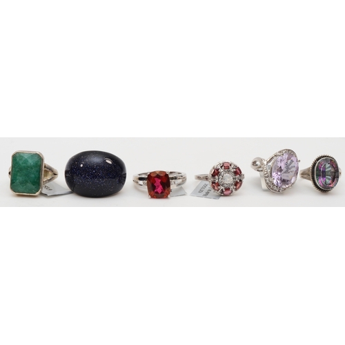 124 - Six silver rings to include a mystic topaz dress ring, O, 45gm.