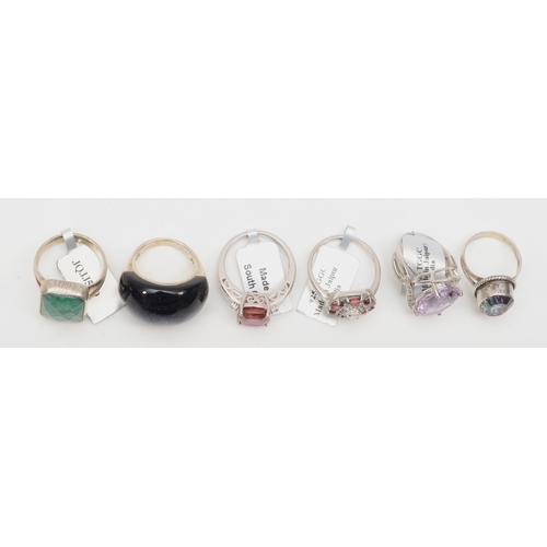 124 - Six silver rings to include a mystic topaz dress ring, O, 45gm.