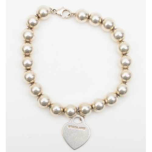 131 - A silver Tiffany & Co bead bracelet with heart shaped tag, 19cm, 17gm.