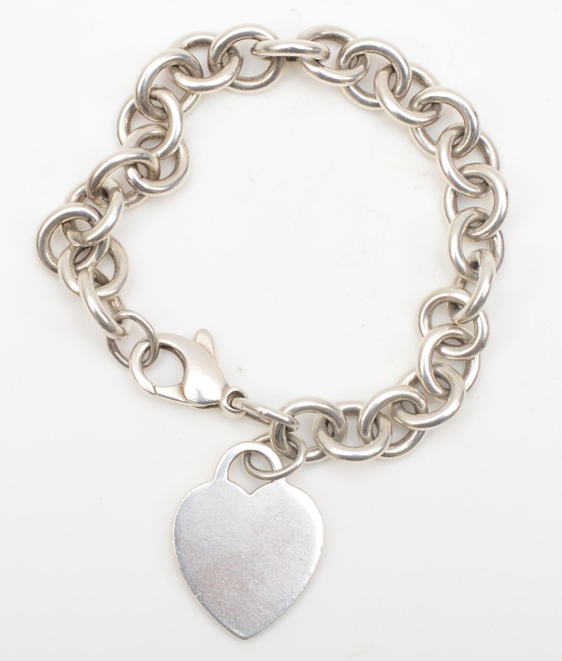 A silver Tiffany & Co bracelet with heart shaped tag, 26 x 20mm, 35gm.