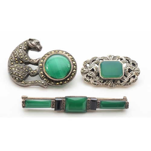 139 - Three silver marcasite and paste stone brooches to include a tiger on a ball brooch, 39 x 21mm, 27gm... 