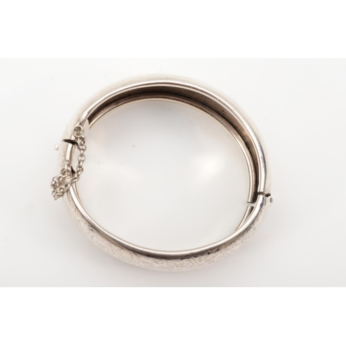 142 - A Victorian silver snap bangle with chased foliate decoration,  maker rubbed, Birmingham 1890, 58 x ... 