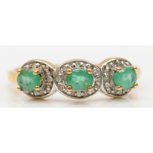 167 - A 9ct gold three stone emerald dress ring, with eight cut diamond surrounds, P, 2.1gm.