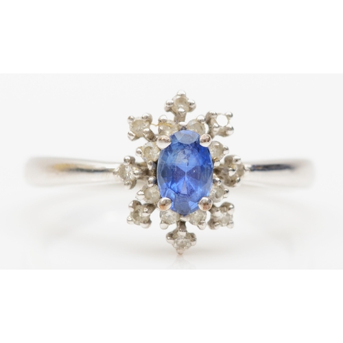 170 - A 9ct white gold sapphire and diamond cluster ring, R, 2.5gm.