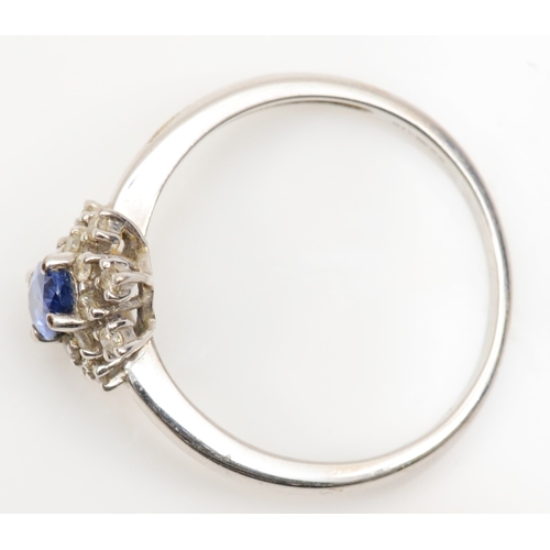 170 - A 9ct white gold sapphire and diamond cluster ring, R, 2.5gm.