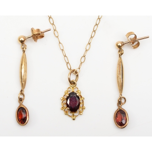 174 - An unmarked gold garnet pendent on 9ct gold chain, 13mm, together with a pair of 9ct gold garnet dro... 