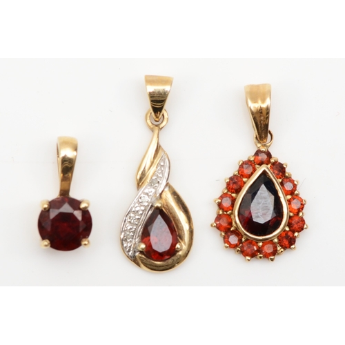 175 - A 9ct gold pear cut garnet cluster pendant, 20 x 10mm, together with two unmarked gold pendants, 3gm... 