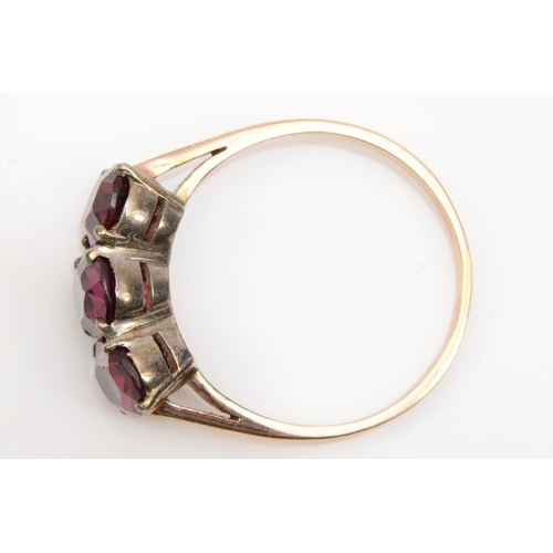 195 - An unmarked gold purple paste stone dress ring, S, 3.3gm.