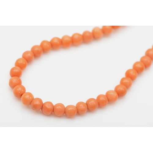 200 - A 9ct gold clasped coral bead necklace, 54cm, together with another 9ct gold clasped coral necklace.