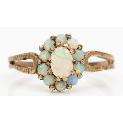 202 - A 9ct gold opal cluster ring, flashes of blue, green and orange, O-P, 1.9gm.