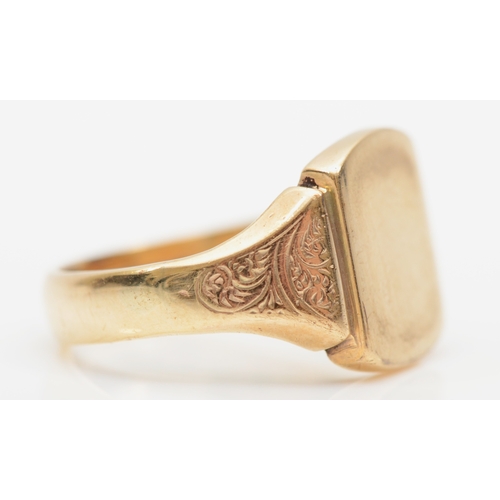 215 - A George VI 9ct gold signet ring, with chased scroll shoulders, Birmingham 1939, O, 6.2gm.