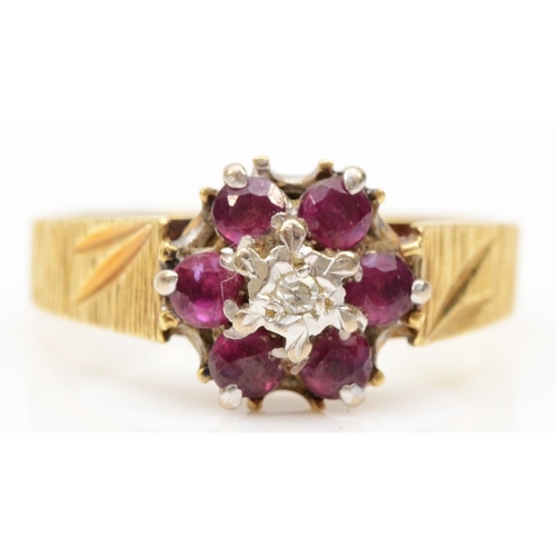 218 - An 18ct gold ruby and illusion set diamond cluster ring, N-O, 3.5gm.