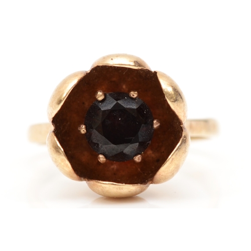 219 - A 9ct gold single stone garnet flower ring, K-L, 3.3gm.