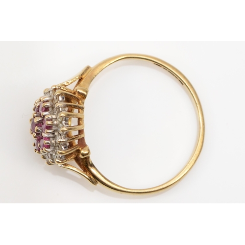 221 - A 9ct gold ruby and eight cut diamond floral cluster ring, L, 2gm.