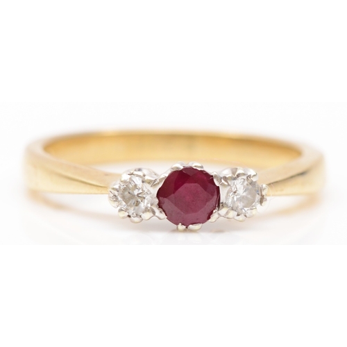 224 - A 9ct gold three stone ruby and brilliant cut diamond dress ring, L, 2.3gm.