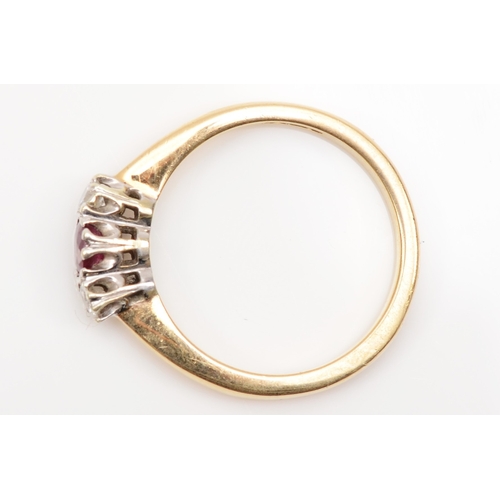 A 9ct gold three stone ruby and brilliant cut diamond dress ring, L, 2.3gm.