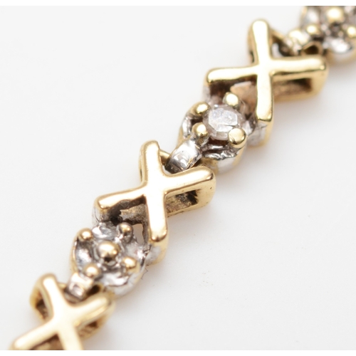 233 - A 9ct gold illusion set diamond cross bracelet, 20.5cm, 3.4gm.