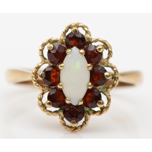 234 - A 9ct gold garnet and opal dress ring, flashes of blue, green and orange, P, 3gm.