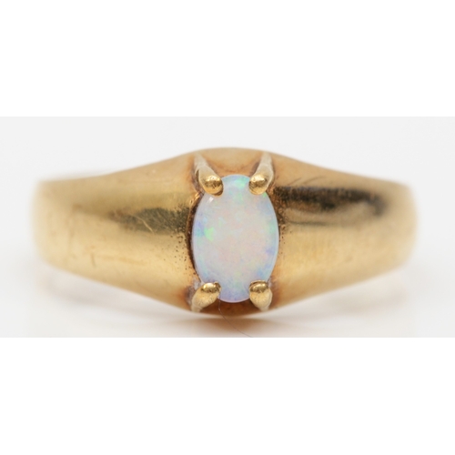 239 - A 9ct gold single stone opal dress ring, flashes of green and blue, N, 2.5gm.