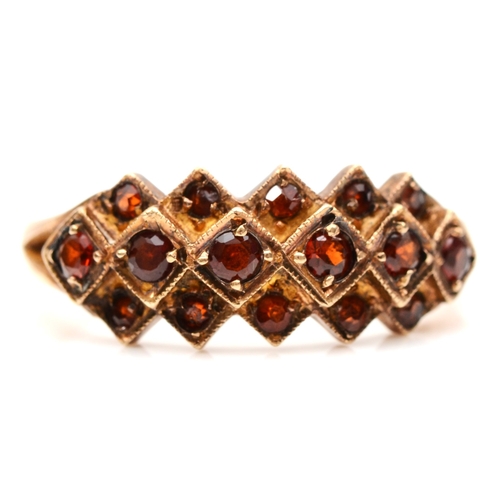 245 - A 9ct rose gold garnet dress ring, Q-R, 3.6gm.