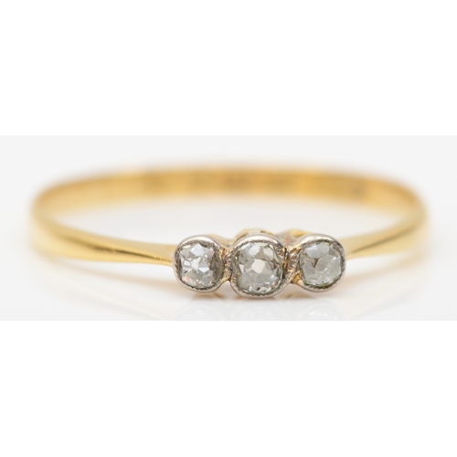 251 - A 18ct gold three stone old cut diamond dress ring, London 1924, R, 1.4gm.