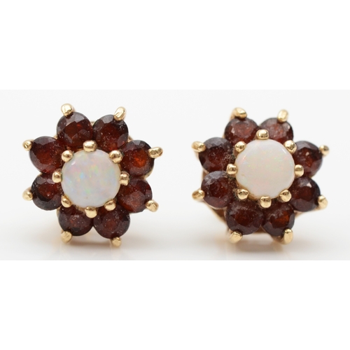 253 - A pair of 9ct gold opal and garnet floral cluster stud earrings, flashes of red, green and blue, 11m... 