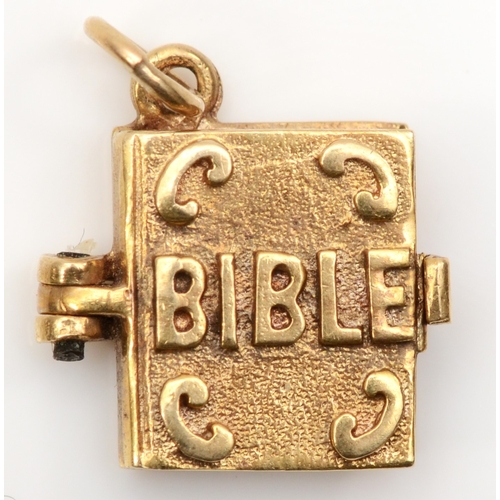 255 - A 9ct gold Bible book charm with the lords prayer, 11 x 13mm, 2.3gm.