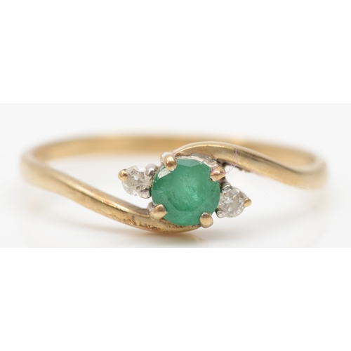 258 - A 9ct gold three stone emerald and eight cut diamond dress ring, O, 1.1gm.