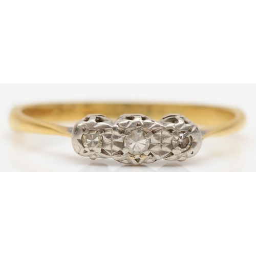 259 - An 18ct gold three stone illusion set diamond ring, M, 1.9gm.