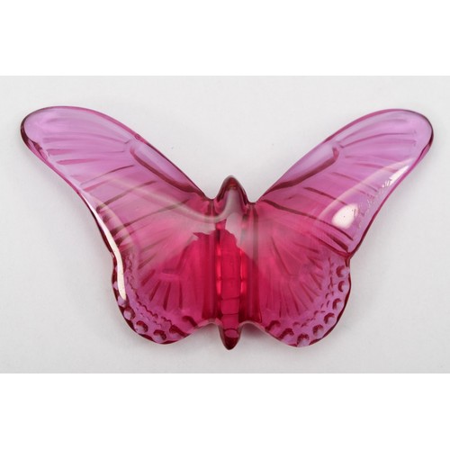 275 - Lalique, a pink glass butterfly pendant on silk cord, 58 x 33mm, original box and bag.