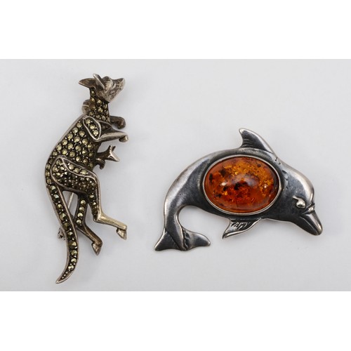 149 - A German silver and marcasite kangaroo brooch, 46 x 30mm, together with a Baltic amber and silver do... 